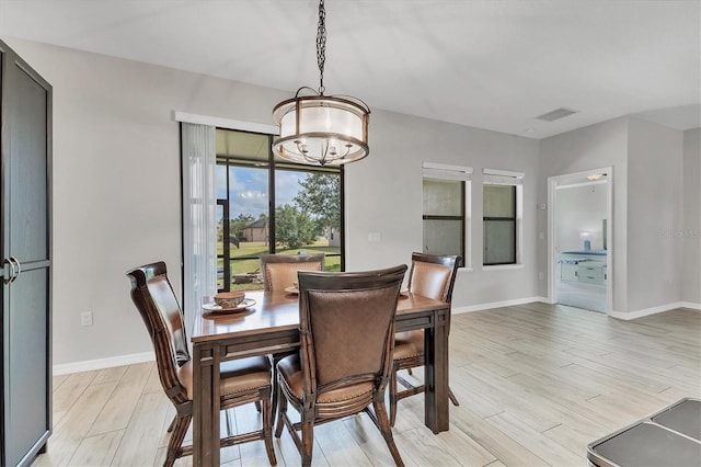7418 61st St E, Palmetto, FL 34221 - dining room featuring visible vents, baseboards, a chandelier, and light wood finished floors