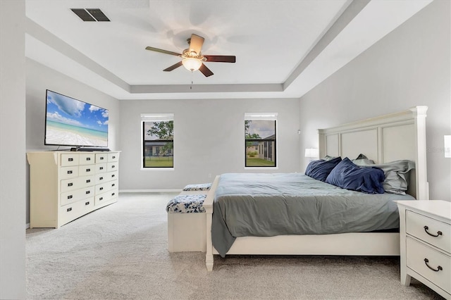 7418 61st St E, Palmetto, FL 34221 - bedroom featuring visible vents, baseboards, light colored carpet, a raised ceiling, and a ceiling fan