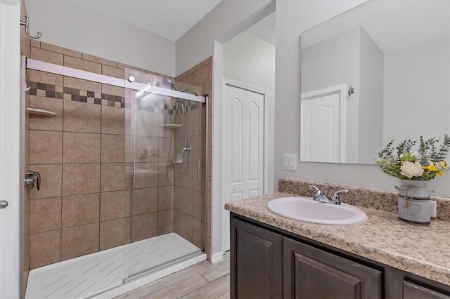 7418 61st St E, Palmetto, FL 34221 - full bathroom featuring a shower stall, wood finished floors, and vanity