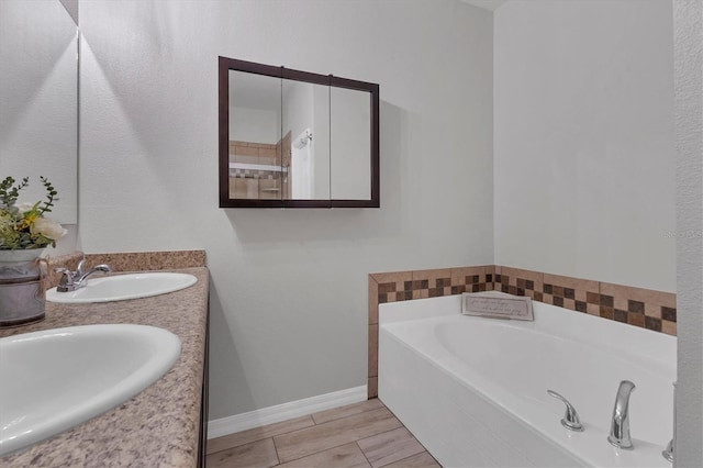 7418 61st St E, Palmetto, FL 34221 - full bath featuring a sink, baseboards, a garden tub, and double vanity