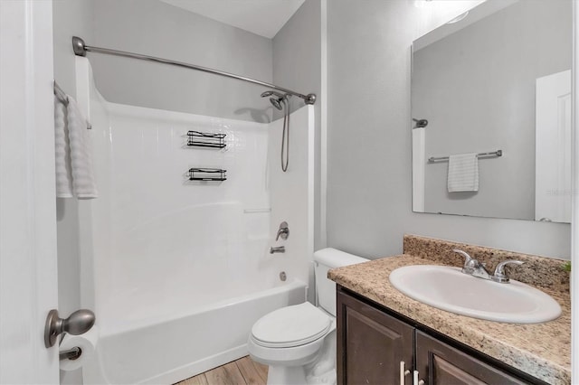 7418 61st St E, Palmetto, FL 34221 - full bathroom with vanity, washtub / shower combination, toilet, and wood finished floors