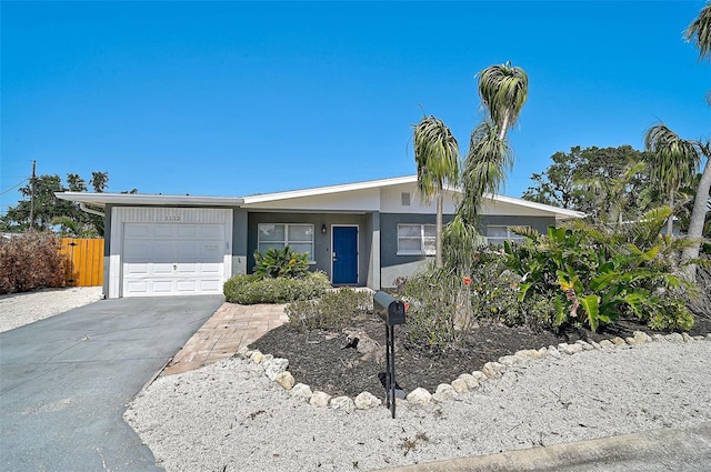 1112 65th St NW, Bradenton, FL 34209 - ranch-style home with an attached garage, stucco siding, fence, and concrete driveway
