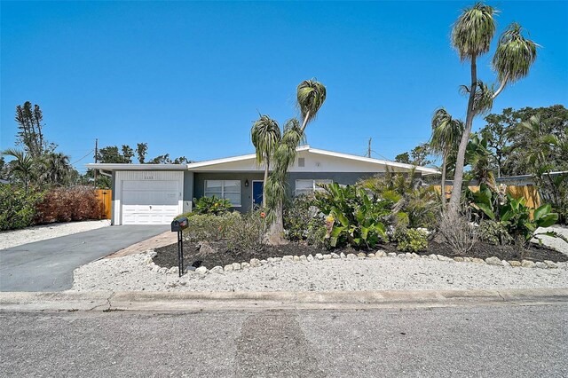 1112 65th St NW, Bradenton, FL 34209 - view of front facade with an attached garage, driveway, and stucco siding