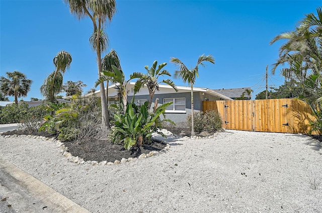 1112 65th St NW, Bradenton, FL 34209 - view of property exterior with fence, a gate, and stucco siding