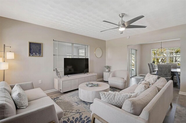 1112 65th St NW, Bradenton, FL 34209 - living room featuring baseboards, ceiling fan, and wood finished floors