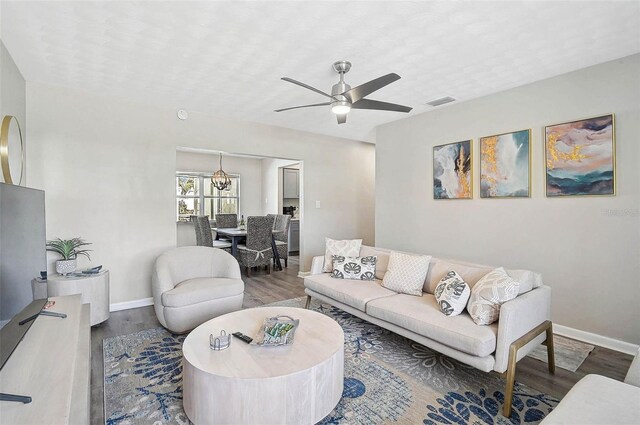 1112 65th St NW, Bradenton, FL 34209 - living room featuring baseboards, visible vents, wood finished floors, and ceiling fan with notable chandelier