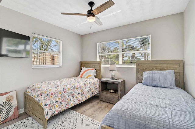 1112 65th St NW, Bradenton, FL 34209 - bedroom with ceiling fan, baseboards, multiple windows, and wood finished floors