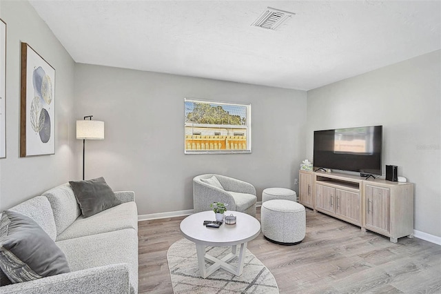 1112 65th St NW, Bradenton, FL 34209 - living room featuring baseboards, visible vents, and light wood-style floors