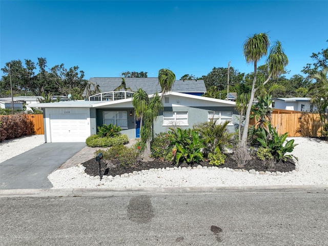 1112 65th St NW, Bradenton, FL 34209 - view of front of house with fence, stucco siding, driveway, and a garage