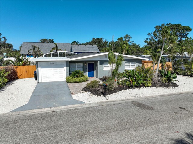 1112 65th St NW, Bradenton, FL 34209 - view of front facade featuring stucco siding, aphalt driveway, fence, and a garage