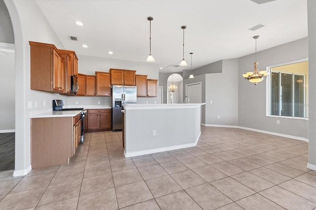 kitchen featuring stainless steel appliances, brown cabinets, an inviting chandelier, light countertops, and baseboards