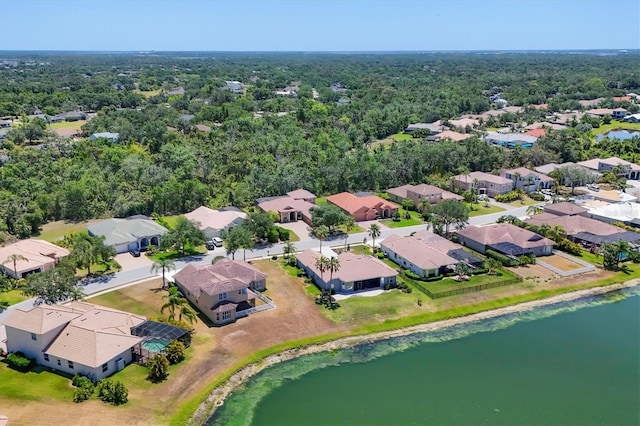 drone / aerial view with a water view and a residential view