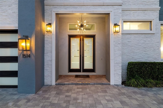 1514 Corolla Ct, Reunion, FL 34747 - view of exterior entry featuring french doors and stone siding