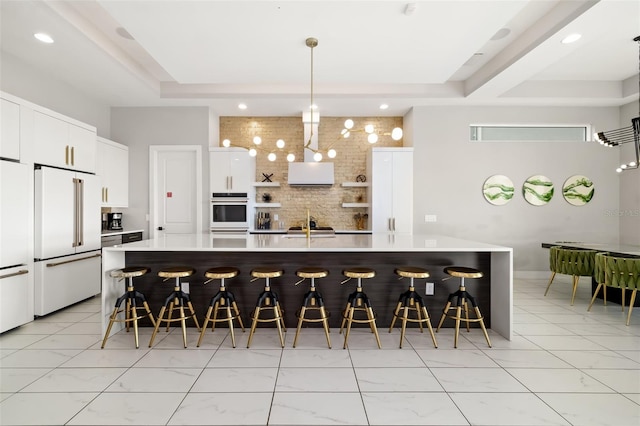 1514 Corolla Ct, Reunion, FL 34747 - kitchen featuring white appliances, a kitchen breakfast bar, light countertops, open shelves, and wall chimney exhaust hood