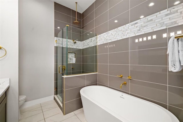 1514 Corolla Ct, Reunion, FL 34747 - bathroom with a shower stall, a freestanding tub, vanity, toilet, and tile patterned flooring