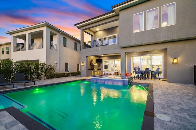 1514 Corolla Ct, Reunion, FL 34747 - pool at dusk featuring a pool with connected hot tub, a patio area, and outdoor dining area