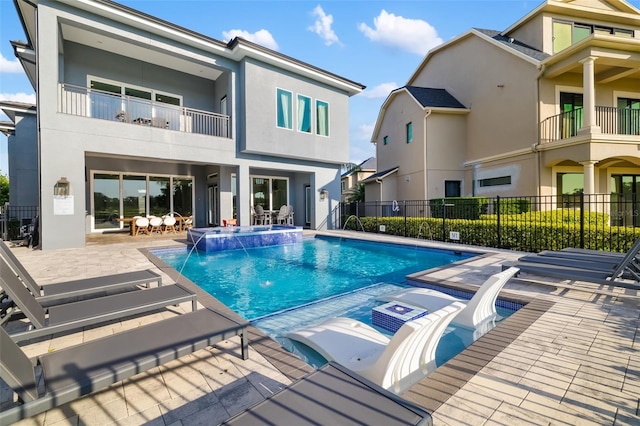1514 Corolla Ct, Reunion, FL 34747 - view of swimming pool with a pool with connected hot tub, fence, and a patio