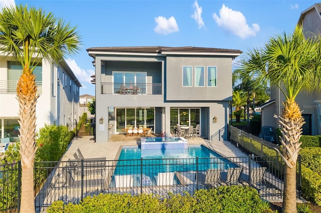 1514 Corolla Ct, Reunion, FL 34747 - back of property with a balcony, stucco siding, a fenced backyard, and a patio