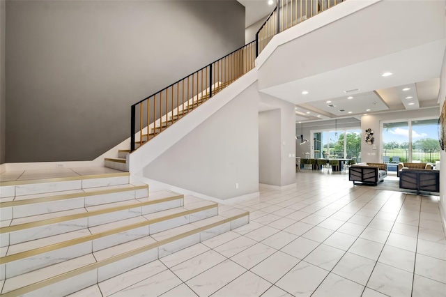 1514 Corolla Ct, Reunion, FL 34747 - stairs with baseboards, recessed lighting, a towering ceiling, and a raised ceiling