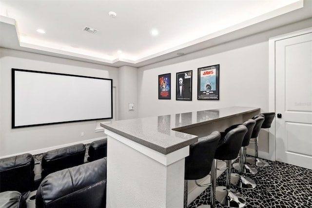 1514 Corolla Ct, Reunion, FL 34747 - home theater room with a tray ceiling, recessed lighting, a bar, and baseboards