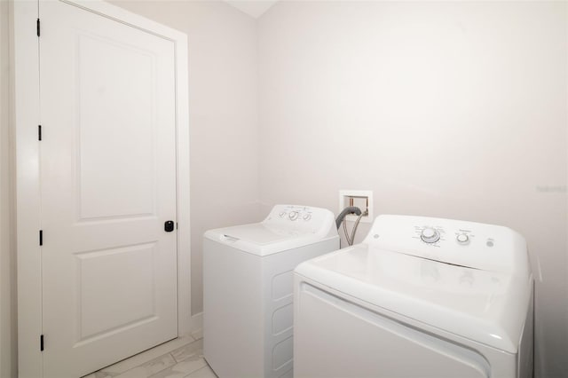 1514 Corolla Ct, Reunion, FL 34747 - laundry area with separate washer and dryer and light marble finish floors