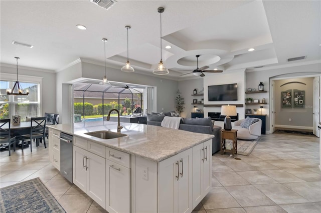 5978 Anise Dr, Sarasota, FL 34238 - kitchen featuring a sink, a kitchen island with sink, ceiling fan with notable chandelier, visible vents, and ornamental molding