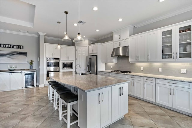 5978 Anise Dr, Sarasota, FL 34238 - kitchen featuring appliances with stainless steel finishes, a sink, white cabinets, wine cooler, and under cabinet range hood
