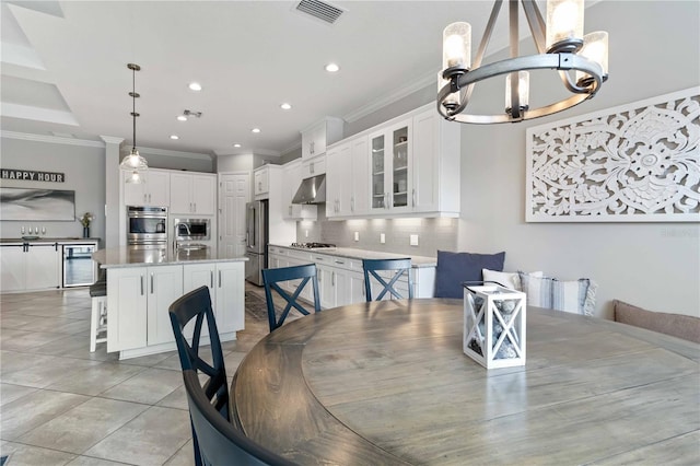 5978 Anise Dr, Sarasota, FL 34238 - dining area featuring visible vents, ornamental molding, beverage cooler, and an inviting chandelier