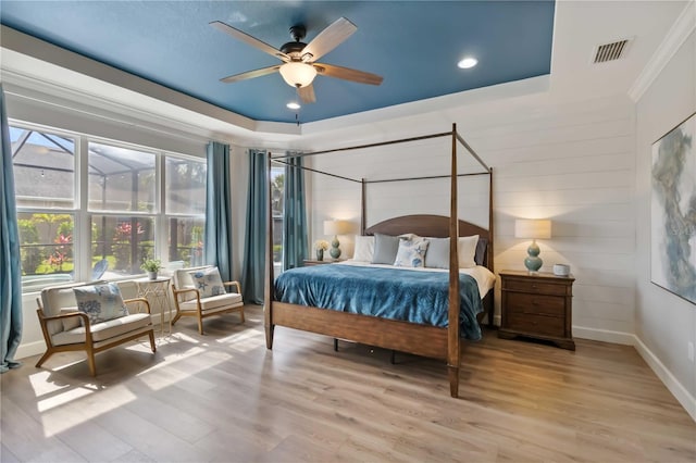5978 Anise Dr, Sarasota, FL 34238 - bedroom with crown molding, light wood-style flooring, recessed lighting, a tray ceiling, and visible vents