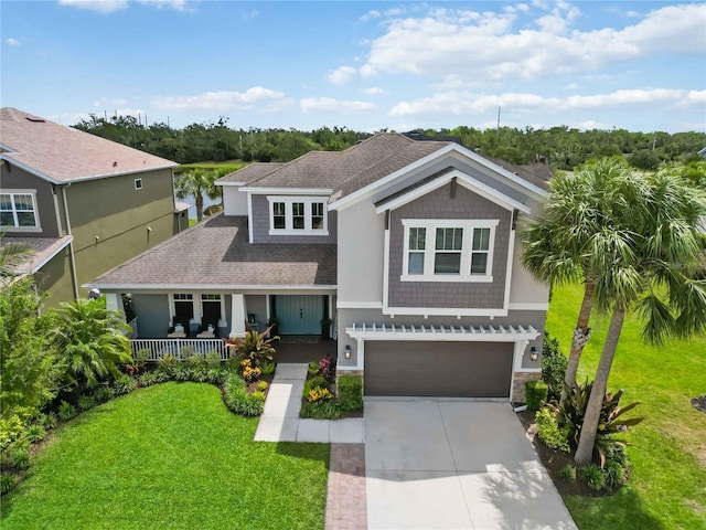 5978 Anise Dr, Sarasota, FL 34238 - craftsman-style home featuring an attached garage, a front lawn, stone siding, a porch, and driveway