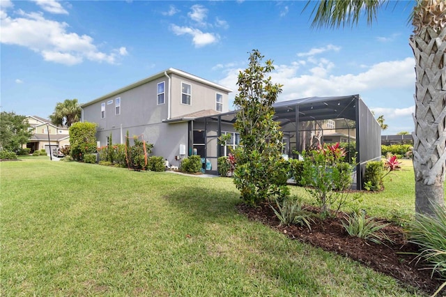 5978 Anise Dr, Sarasota, FL 34238 - back of property featuring a lawn, glass enclosure, and stucco siding
