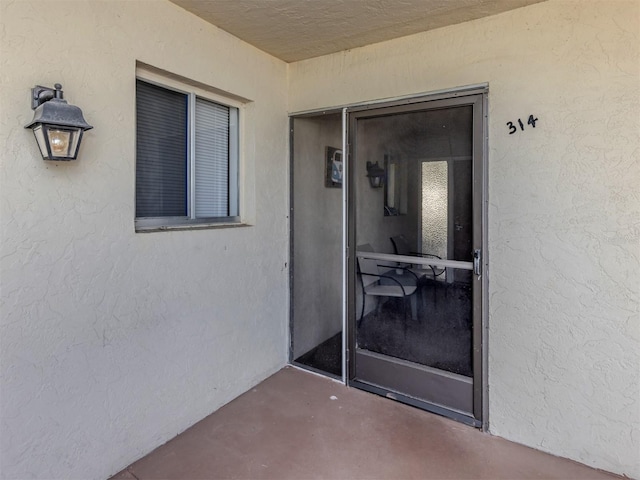 340 Base Ave E Unit 314, Venice, FL 34285 - property entrance with a patio area and stucco siding