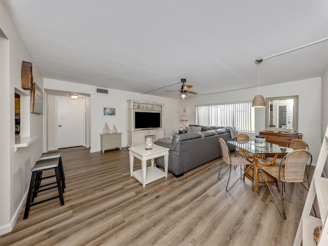 340 Base Ave E Unit 314, Venice, FL 34285 - living room featuring baseboards, ceiling fan, light wood finished floors, and visible vents