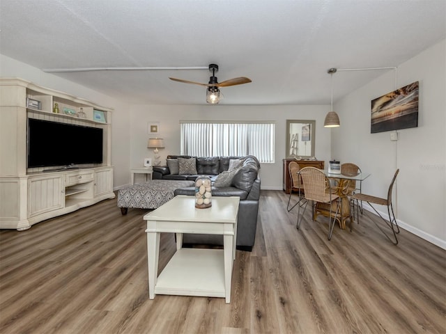 340 Base Ave E Unit 314, Venice, FL 34285 - living area featuring a ceiling fan, baseboards, and wood finished floors