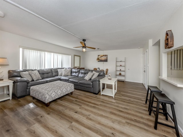 340 Base Ave E Unit 314, Venice, FL 34285 - living area with a textured ceiling, ceiling fan, and wood finished floors