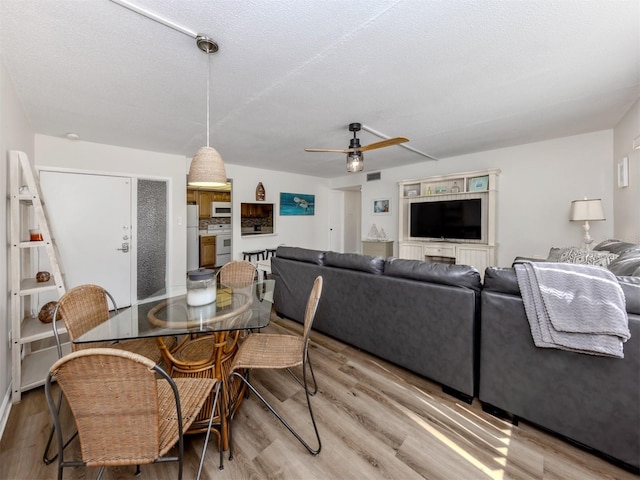 340 Base Ave E Unit 314, Venice, FL 34285 - dining area featuring ceiling fan, visible vents, and wood finished floors