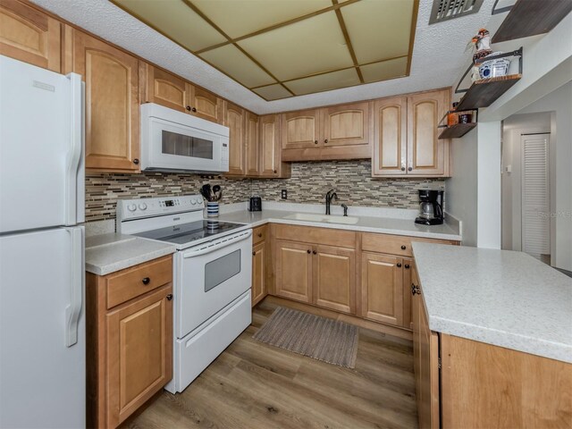340 Base Ave E Unit 314, Venice, FL 34285 - kitchen featuring visible vents, a sink, light countertops, white appliances, and light wood-style flooring