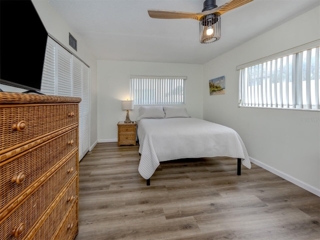 340 Base Ave E Unit 314, Venice, FL 34285 - bedroom featuring baseboards, visible vents, wood finished floors, and a closet