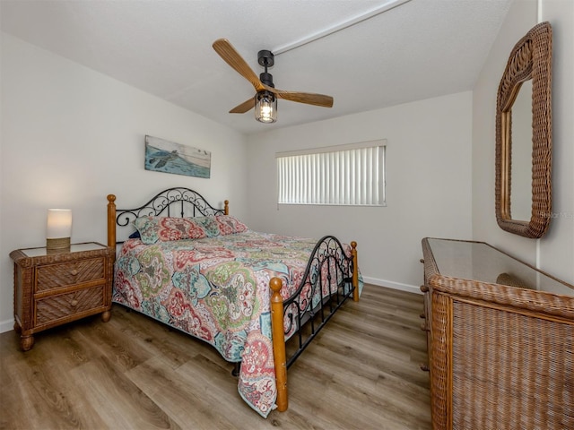 340 Base Ave E Unit 314, Venice, FL 34285 - bedroom with baseboards, a ceiling fan, and wood finished floors
