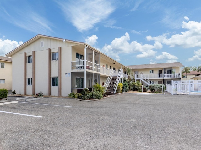 340 Base Ave E Unit 314, Venice, FL 34285 - view of building exterior featuring uncovered parking and stairway