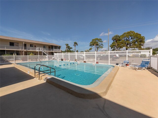 340 Base Ave E Unit 314, Venice, FL 34285 - community pool with fence and a patio area