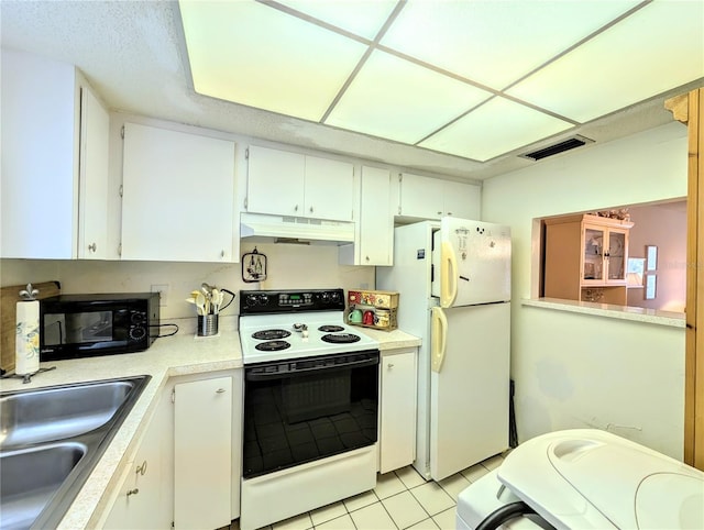 3559 Lake Bayshore Dr Unit J-204, Bradenton, FL 34205 - kitchen with white appliances, white cabinets, under cabinet range hood, and light countertops