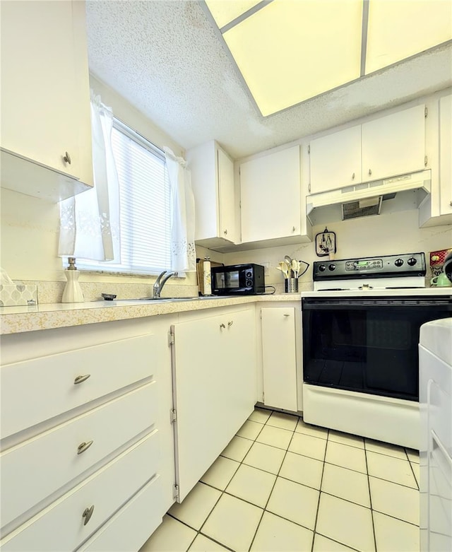 3559 Lake Bayshore Dr Unit J-204, Bradenton, FL 34205 - kitchen with under cabinet range hood, light countertops, white cabinets, and electric stove