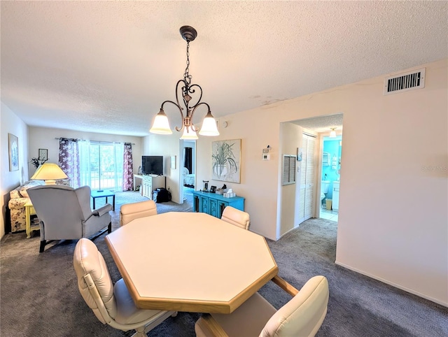 3559 Lake Bayshore Dr Unit J-204, Bradenton, FL 34205 - dining area featuring a chandelier, a textured ceiling, visible vents, and dark colored carpet