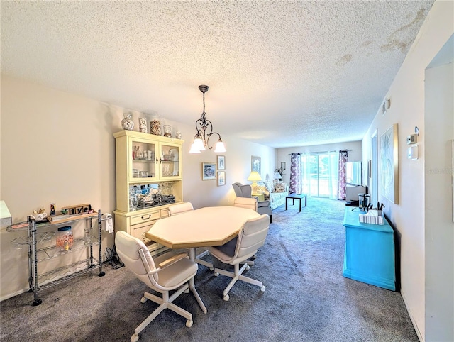 3559 Lake Bayshore Dr Unit J-204, Bradenton, FL 34205 - dining area featuring visible vents, carpet flooring, a textured ceiling, and a chandelier