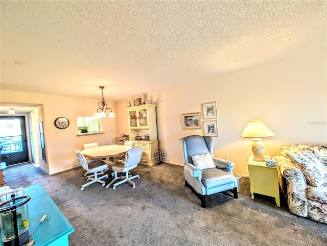 3559 Lake Bayshore Dr Unit J-204, Bradenton, FL 34205 - carpeted dining area with a textured ceiling and a chandelier