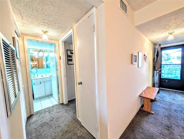 3559 Lake Bayshore Dr Unit J-204, Bradenton, FL 34205 - corridor with baseboards, carpet, a textured ceiling, and visible vents