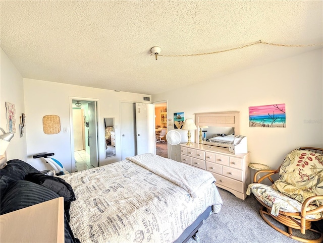 3559 Lake Bayshore Dr Unit J-204, Bradenton, FL 34205 - bedroom with visible vents, carpet flooring, and a textured ceiling