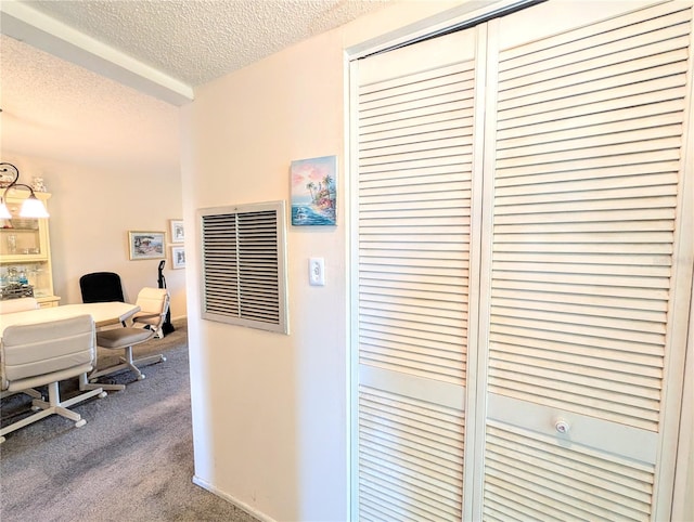 3559 Lake Bayshore Dr Unit J-204, Bradenton, FL 34205 - hall with dark colored carpet, a textured ceiling, and visible vents