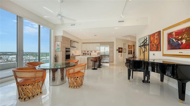 dining room with plenty of natural light, a ceiling fan, light tile patterned floors, and track lighting